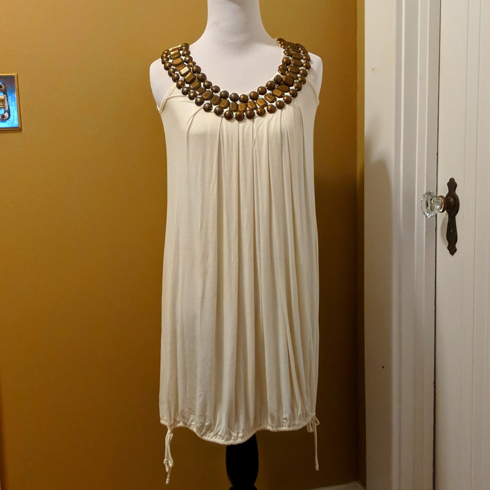 Lightweight cream summer dress with beaded neckline.